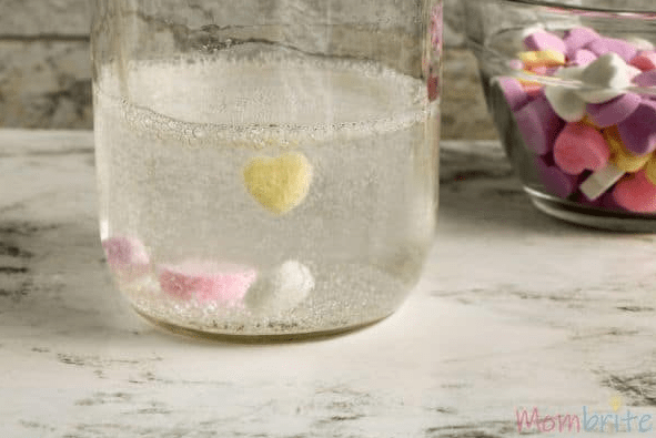 valentines day STEM activities a clear jar with fizzing bubbles on candy hearts