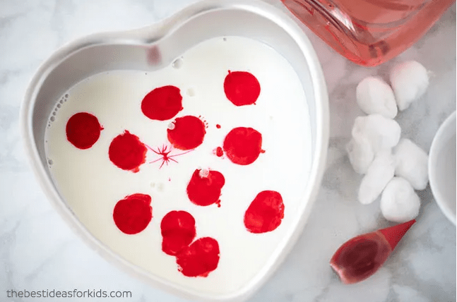 valentines day stem activities a heart shaped container with red blobs over white liquid