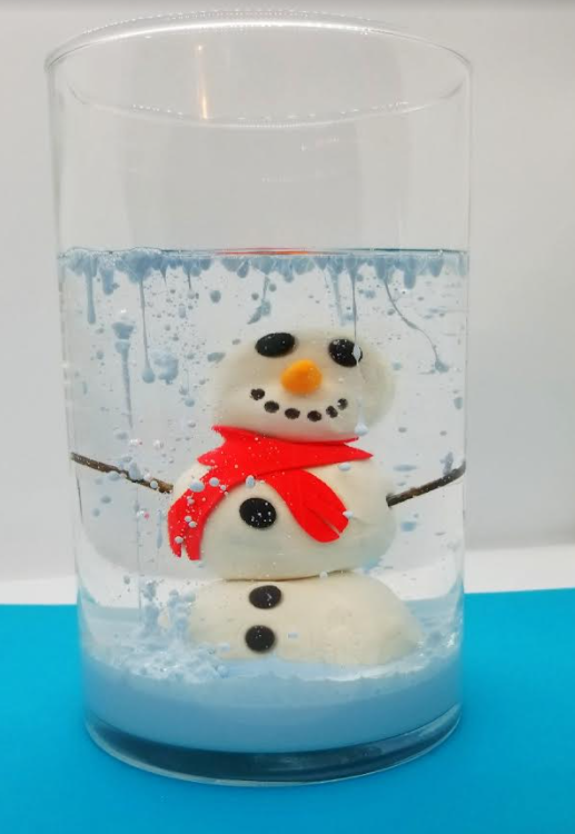 stem activity for kids shows a picture of a clay snowman in a jar with oil and blue paint dripping from the top of the jar