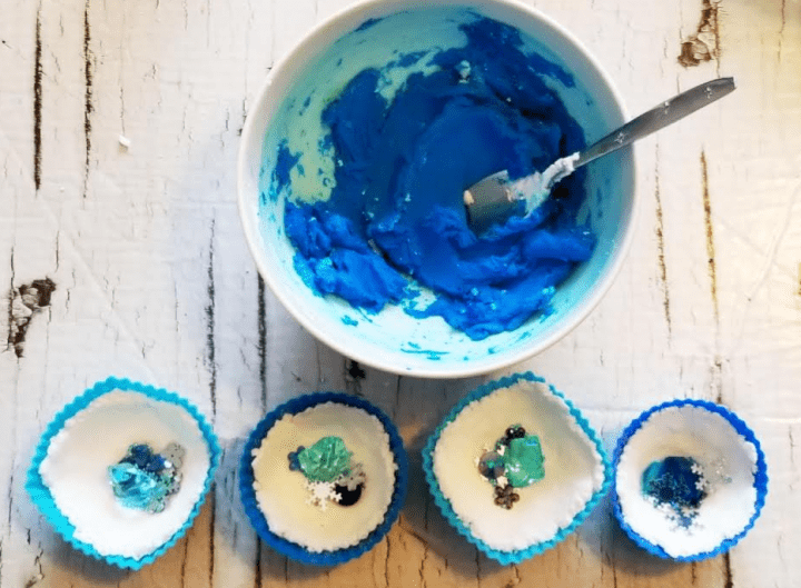 stem for kids shows a bowl with blue mixture and 4 cupcake liners with gems and decorations in them.