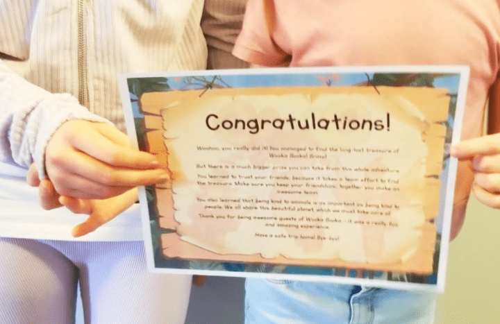 escape room certificate shows two children holding an escape room certificate