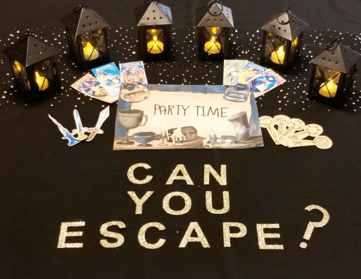 escape room image of printed pages candle lanterns and the words can you escape?
