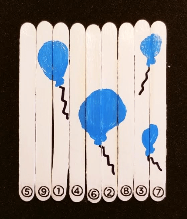 Escape room for kids completed popsicle stick puzzle shows 4 blue balloons
