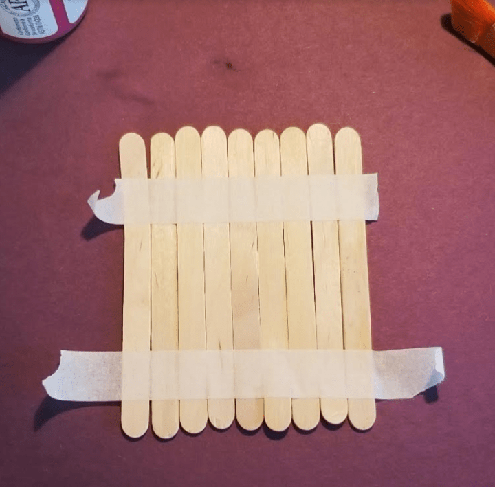 diy puzzles for kids shows 9 popsicle sticks taped together.