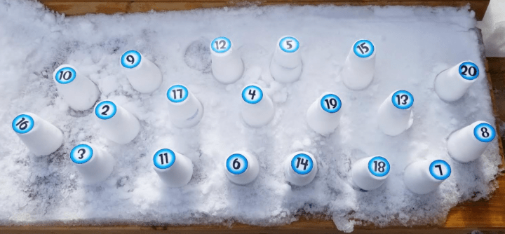 outdoor learning activity shows a view from above of snow towers with number on top 1-20