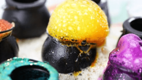 STEM activities for kids shows a fizzing yellow bubbly material coming out of a black cauldron
