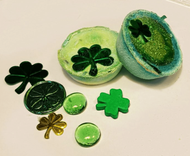 STEM activities for kids shows green pucks with shamrocks and coins