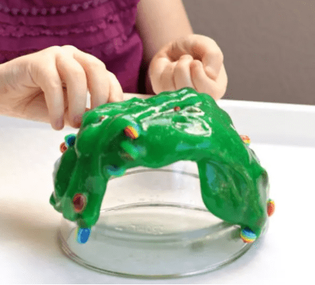 STEM activities for kids shows green slime with small rainbow pieces in it