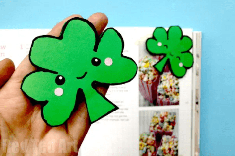 Math activities for kids shows an image of green shamrock with a cute face being held by a hand