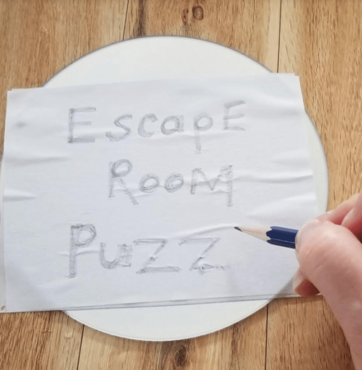 escape room puzzles shows someone writing escape room puzz....
