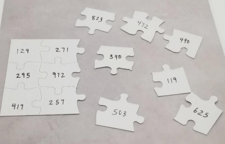 DIY escape room shows a half finished puzzle with a number on each piece