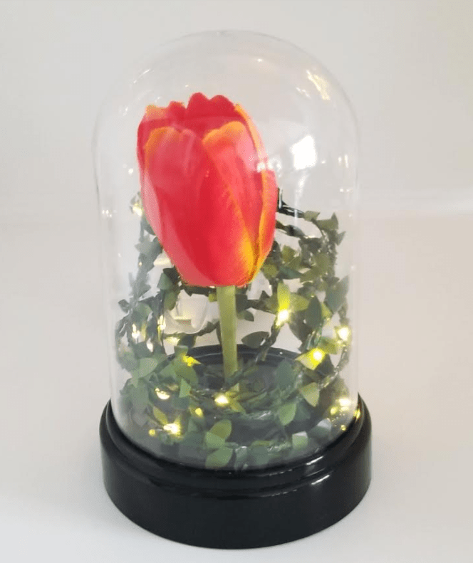 escape room for kids shows a display jar with a rose and light up vines inside