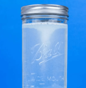 STEM science experiment shows a canning jar with a twirling swirl of water inside.