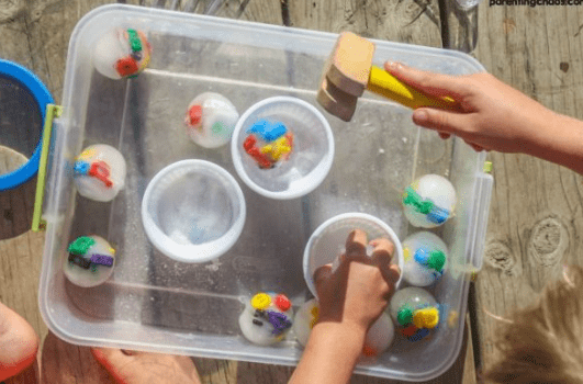 phonemic awareness shows a bin with frozen balls with alphabet items in each