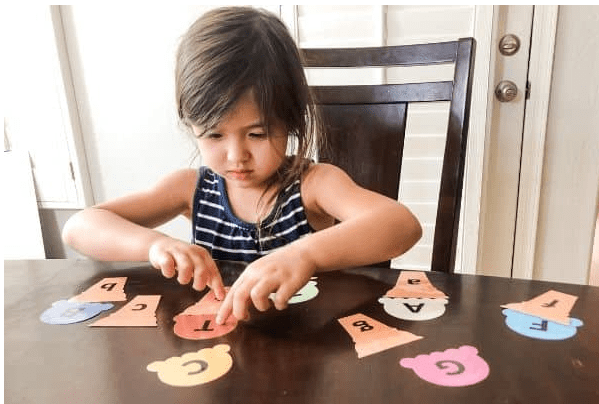 letter games shows a child putting letters together with ice cream cut outs