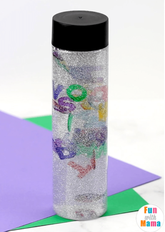 sensory play for kids shows a calming sensory bottle with letters throughout