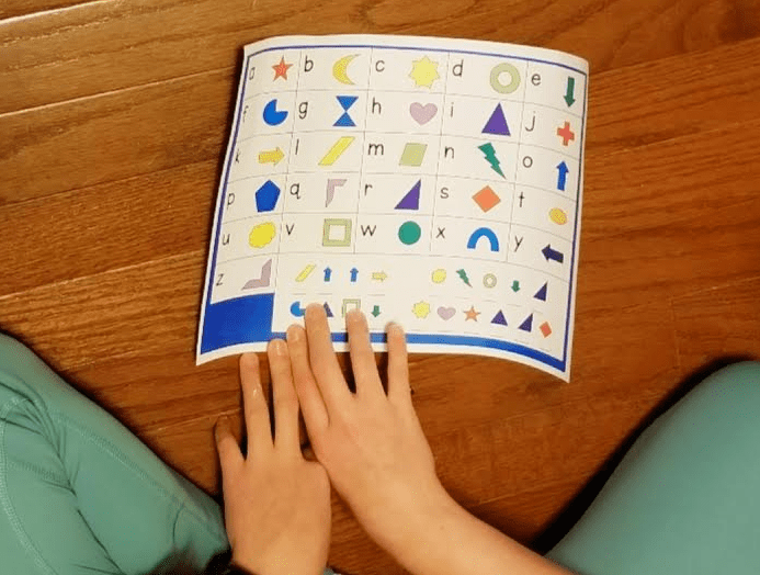 free printable escape room shows a child looking at a colorful alphabet puzzle
