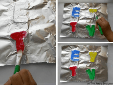 alphabet activity shows a child painting the letters of the alphabet through aluminum foil.