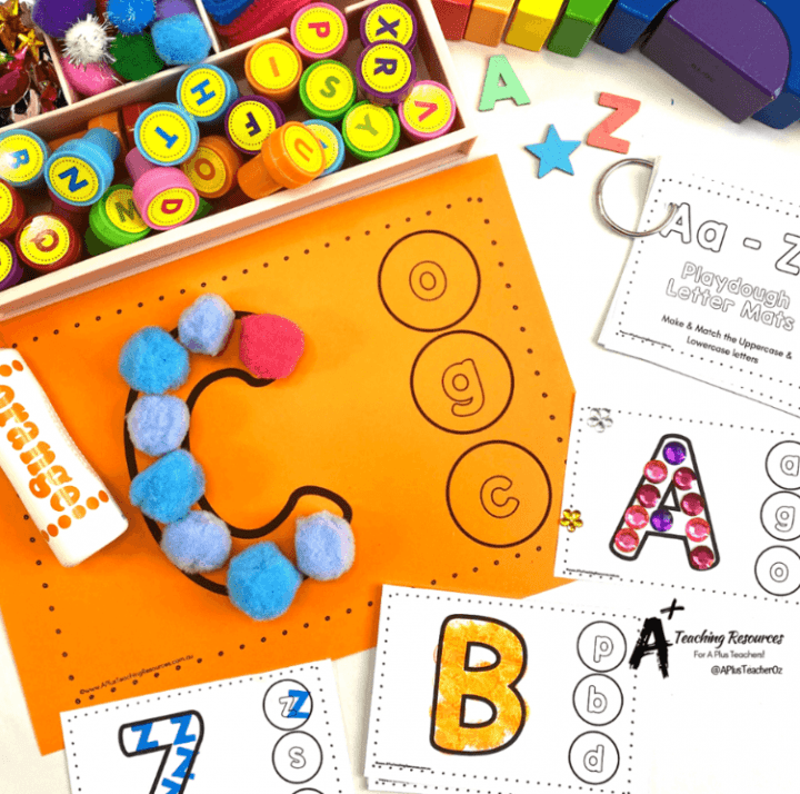 phonemic awareness shows alphabet cards with pompoms making the letter C.