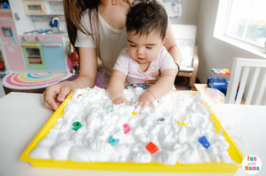 phonological awareness shows a toddler playing in shaving cream with letters hidden throughout.