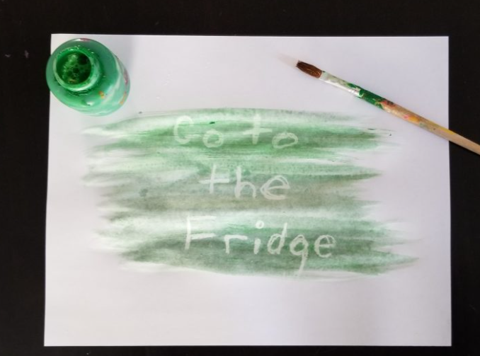 diy escape room shows a paper with paint over top and the words go to the fridge.