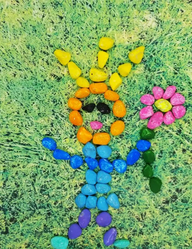 nature art outdoor learning activity classroom shows a critter made from colorful rocks