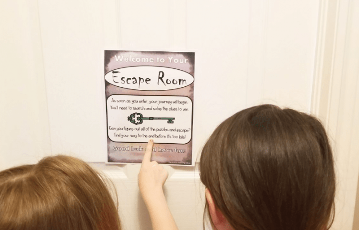 diy escape rooms shows two children pointing at a clue on a door.