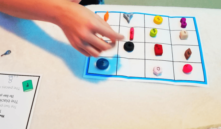 kids escape room shows a child doing the grid and shapes puzzle