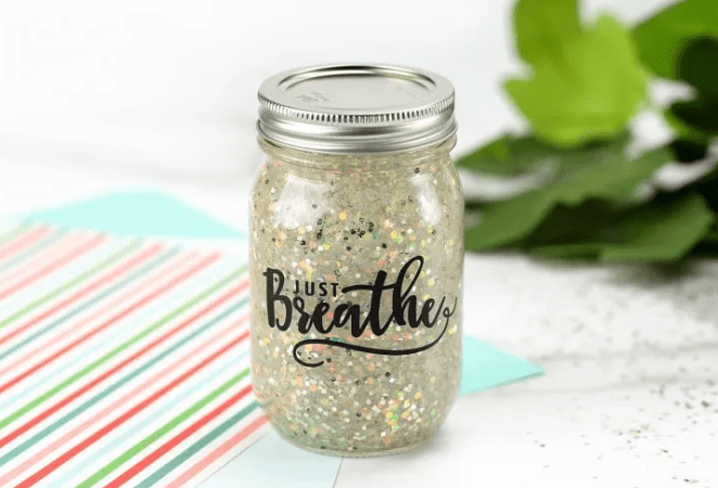 calming jar shows a jar with white and silver sparkles and Just Breathe on the cover