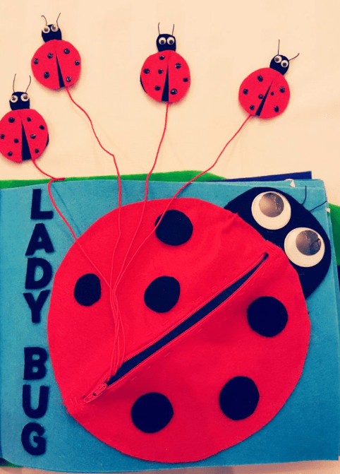 quiet book shows a large ladybug on a felt page