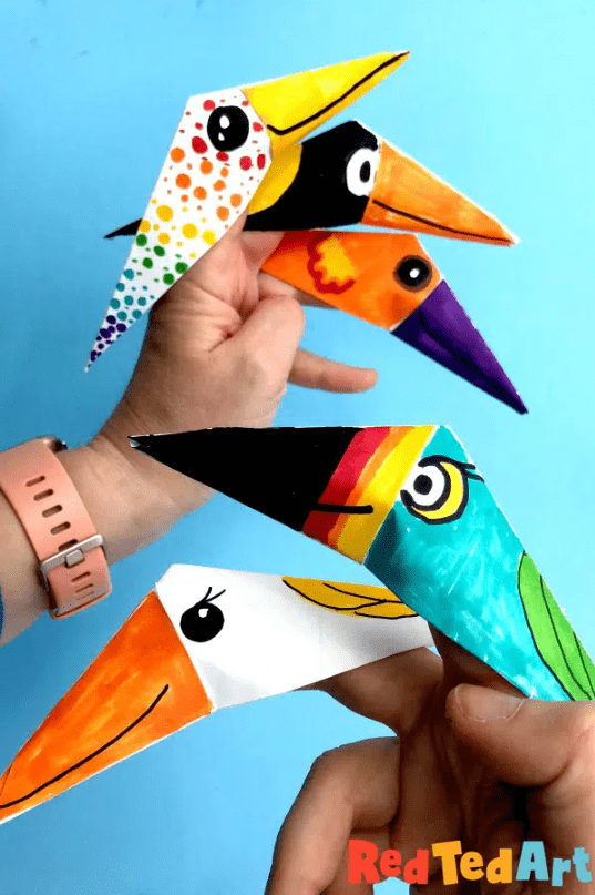 paper crafts and activities shows a hand with paper bird crafts on the fingers.