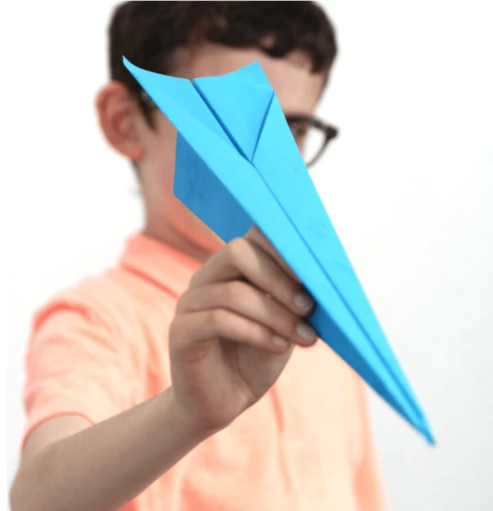 paper crafts and activities shows a child holding a blue paper airplane.