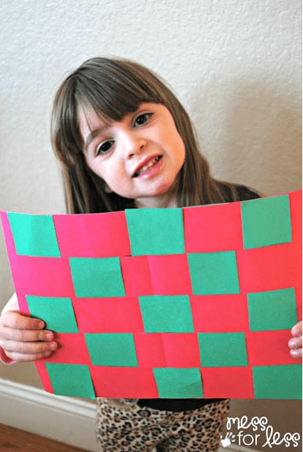 math craft for kids shows a child holding a pattern mat.