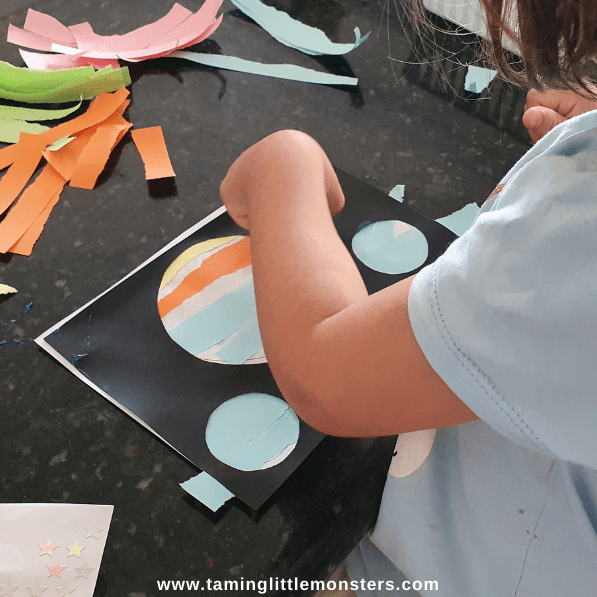 paper crafts and activities shows a child making a space sihouette.