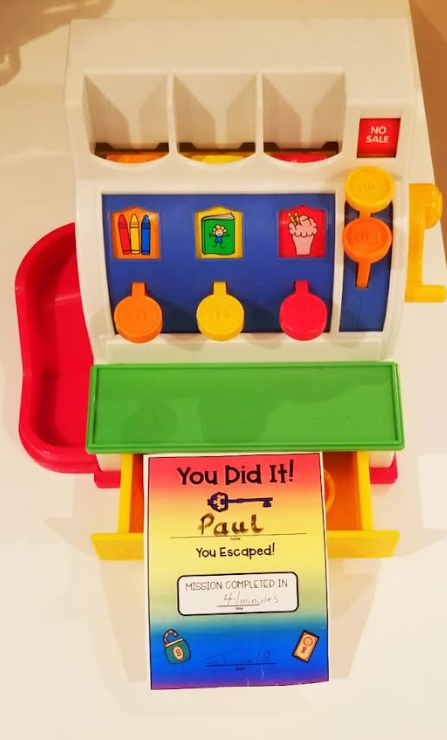 escape room certificate is shown in a toy cash register