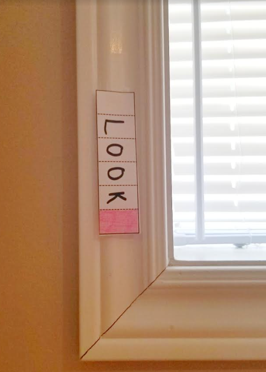 escape room ideas shows the word look taped to a window.