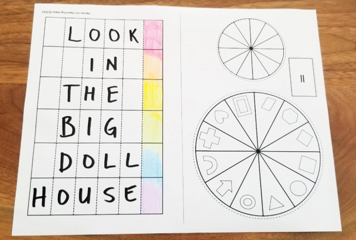 escape room game shows strips of paper with look in the big doll house written on them and a rainbow of color down the side