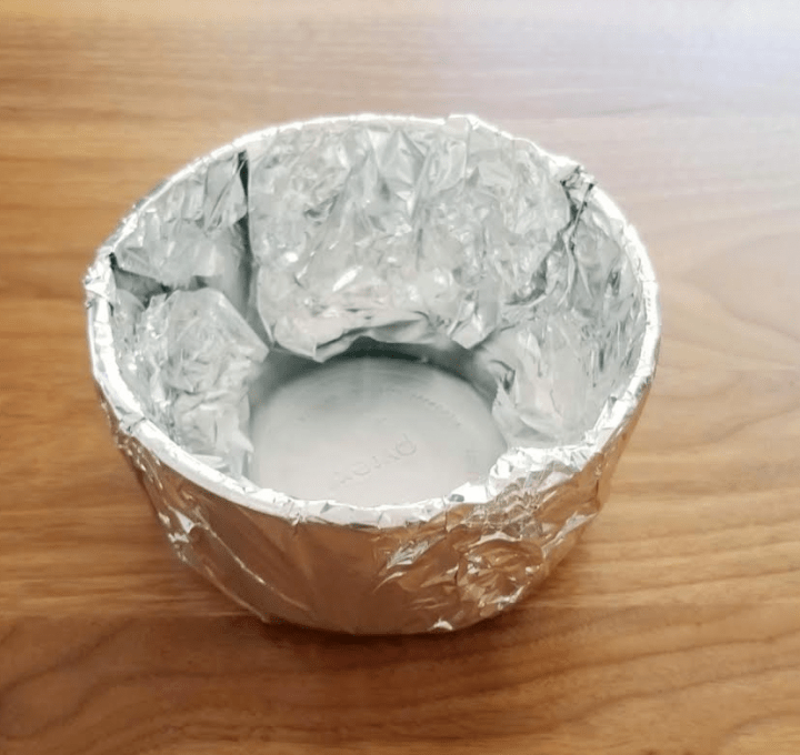 paper mache art project shows a bowl covered in aluminum foil