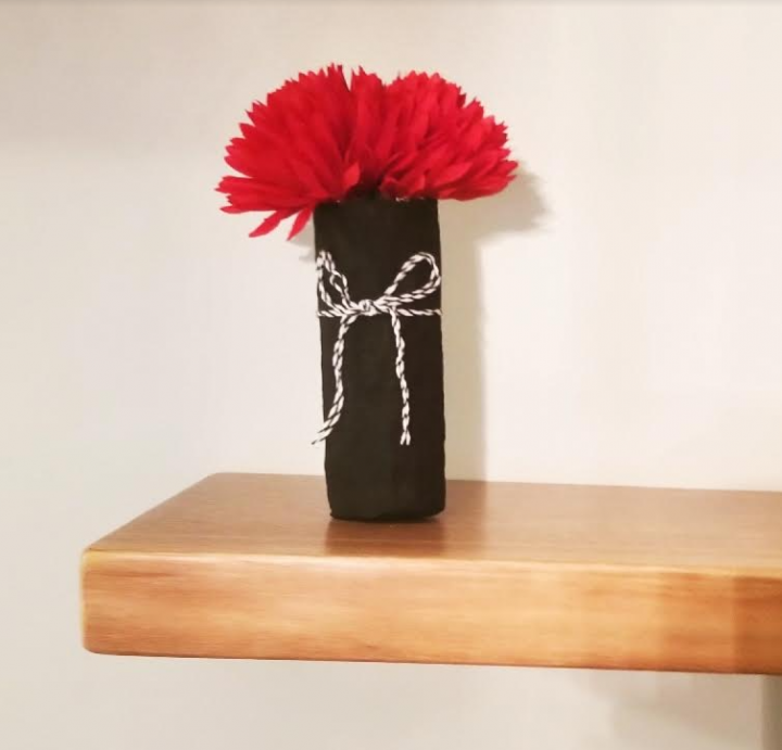 paper mache ideas shows a black flower vase with red flowers