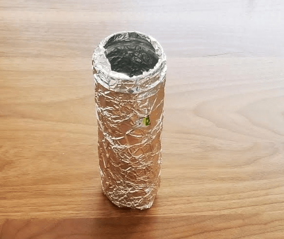 paper mache art project shows a container covered in aluminum foil