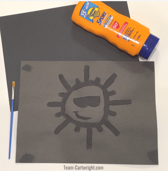 summer stem activity shows a black sheet of paper and sunscreen leaving the print of a sun