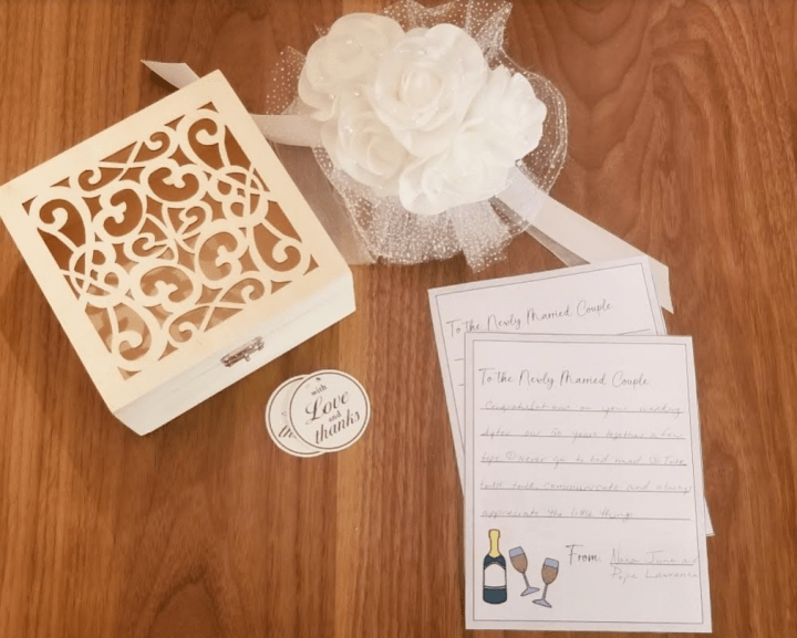 time capsule ideas shows a fancy wooden box, flowers and written letters for a wedding.