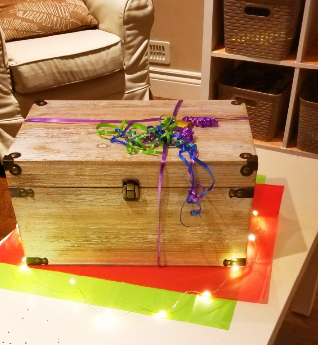 time capsule ideas shows a large treasure box locked with fancy ribbon