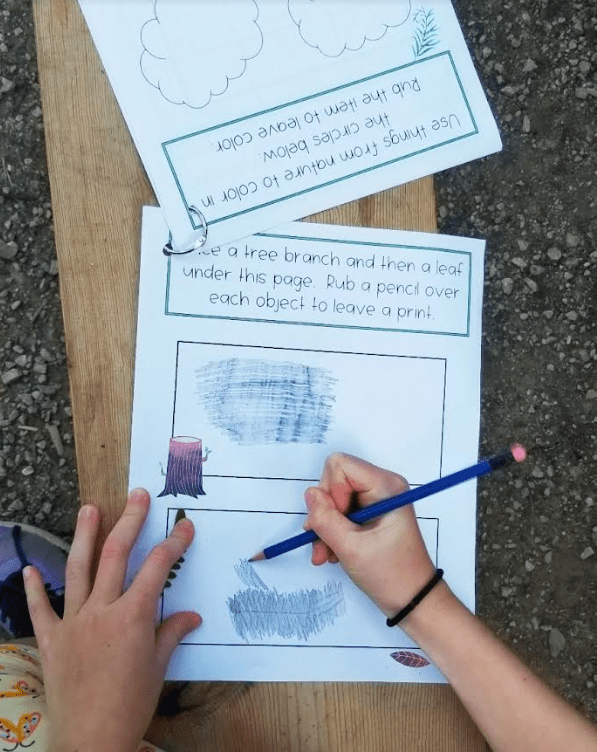 outdoor learning activities shows a child rubbing a leaf under a page.