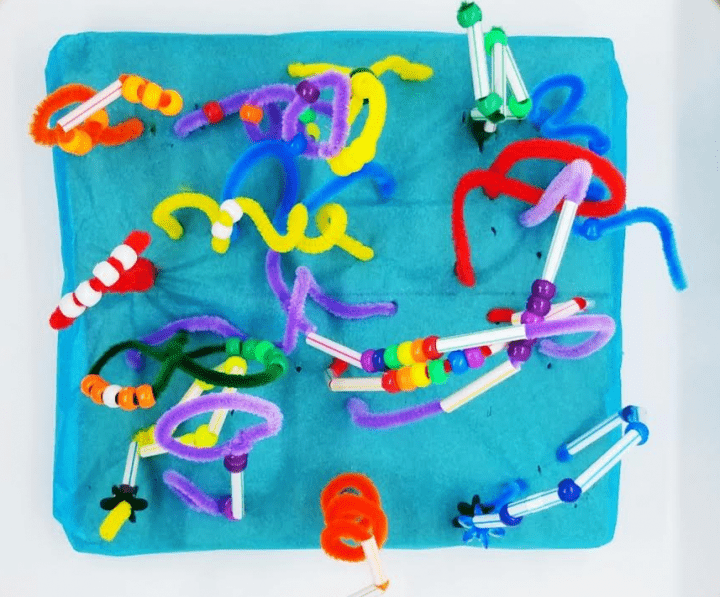 stem for kids shows a colorful structure from beads, straws and pipe cleaners from a birds eye view.