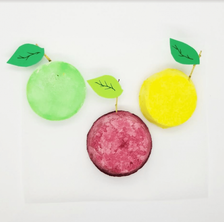 science experiments for kids shows three colored baking soda pucks to look like apples.