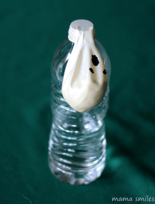 halloween stem shows a water bottle with a white balloon with a ghost drawn on attached to the top.
