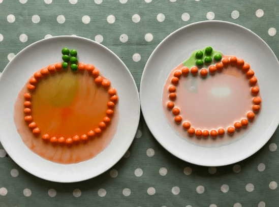 science experiment shows two plates with orange candies forming a pumpkin shape and color melting off.
