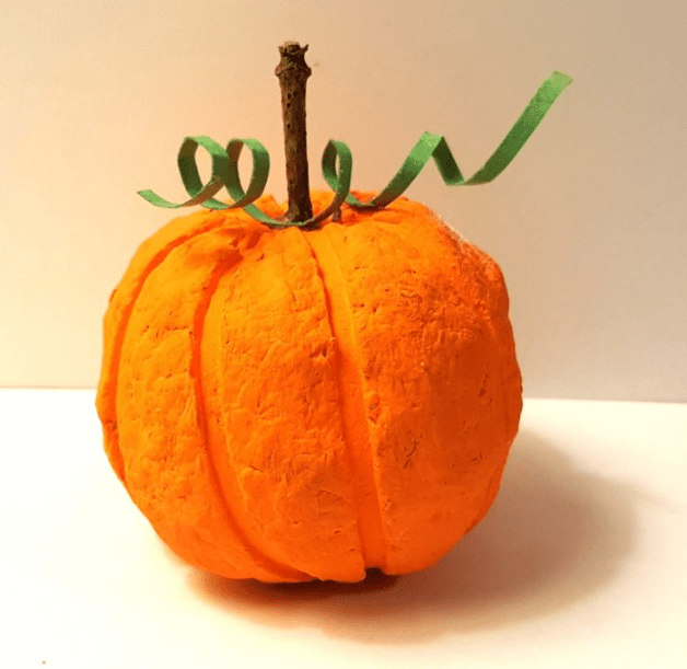 fall crafts shows a pumpkin made from recycled paper.