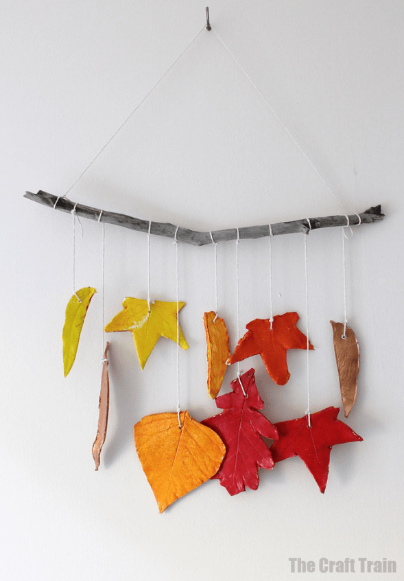 clay leaf mobile shows leaf cut outs painted fall colors.